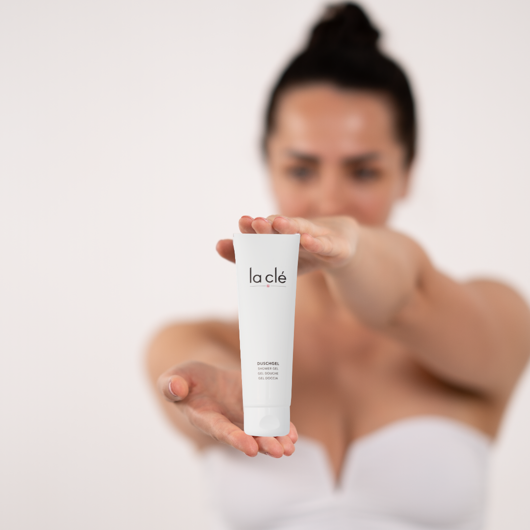 girl holding shower gel tube in her hands